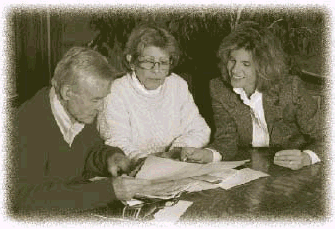 Photograph of three people reviewing paperwork